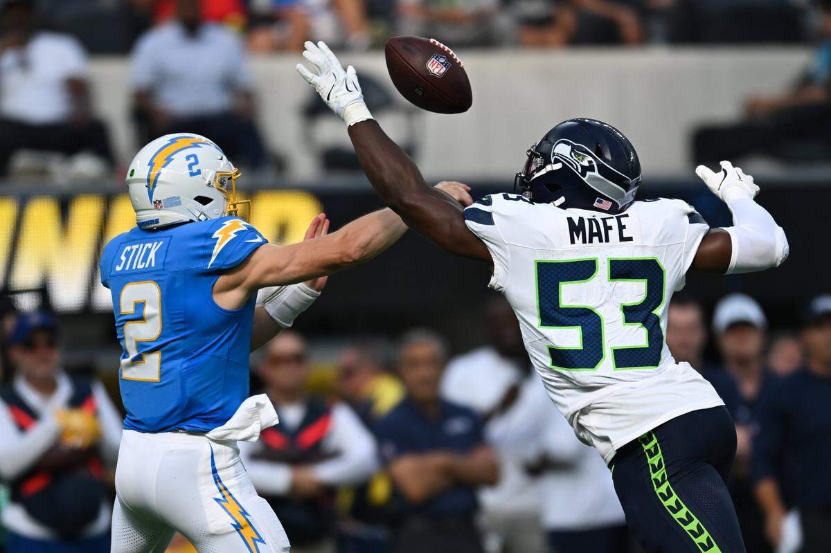 Aug 10, 2024; Inglewood, California, USA; Seattle Seahawks linebacker Boye Mafe (53) blocks a throw from Los Angeles Chargers quarterback Easton Stick (2) during the second quarter at SoFi Stadium. Mandatory Credit: Jonathan Hui-USA TODAY Sports