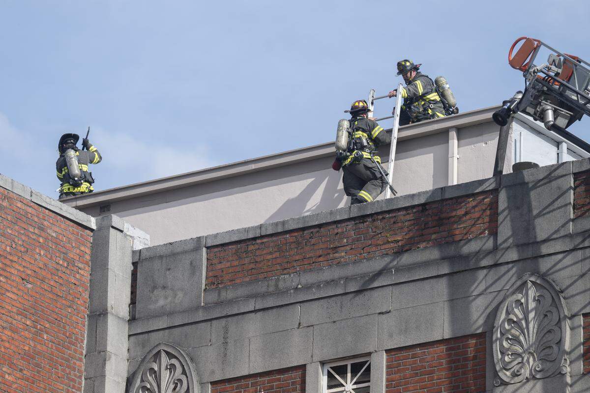 Fire fighters remain on the scene after a fire broke out on the roof of Tacoma’s Temple Theater on Tuesday, May 12, 2026, in Tacoma, Wash.
