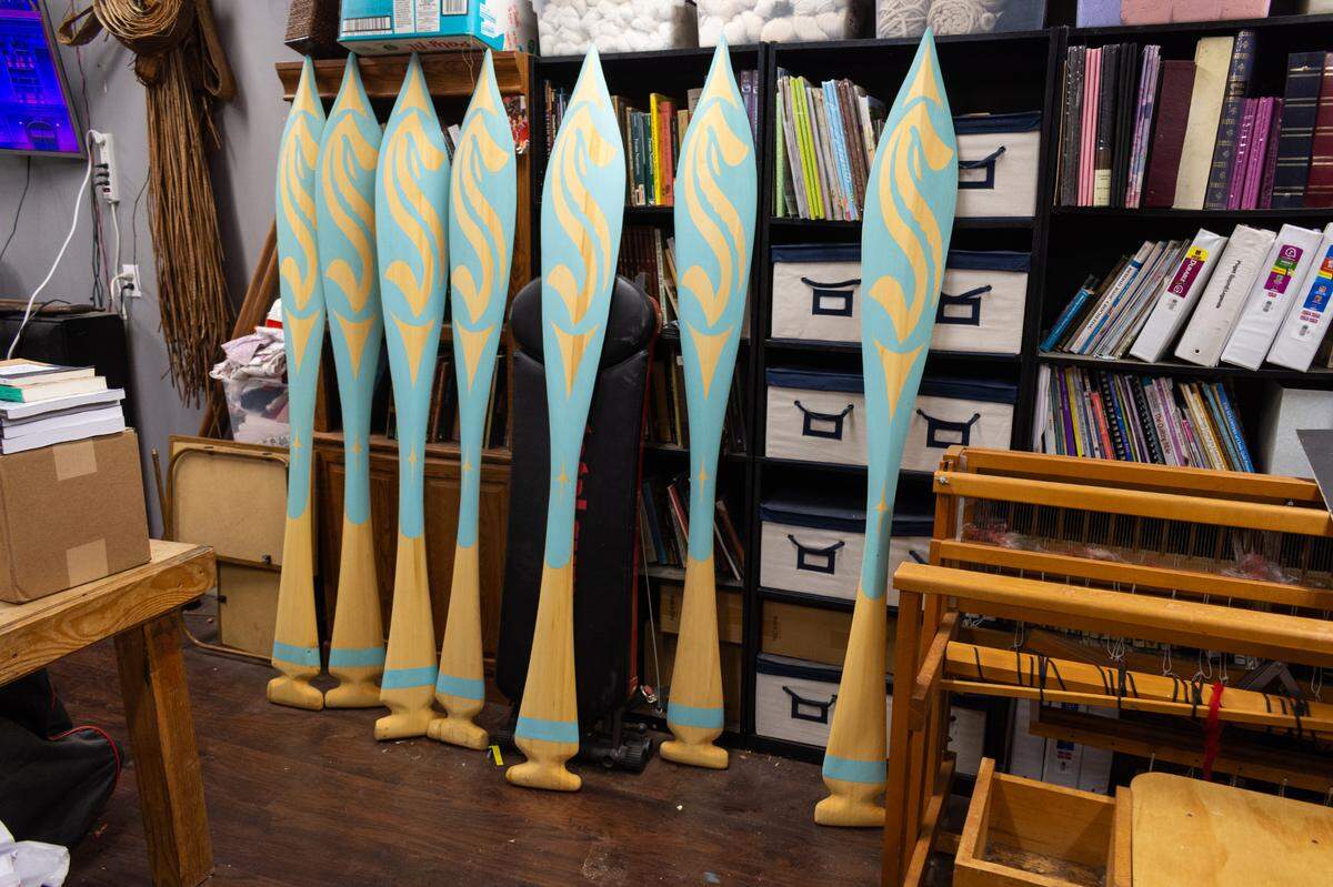 Seven paddles representing the seven generations sit in the Shelton, Wash., workshop of Andrea Wilbur-Sigo, a master carver and member of the Squaxin Island Tribe, on Thursday, Nov. 4. The carver is known for large pieces of public art and was commissioned by the Seattle Kraken hockey team for a piece to be installed at the Kraken Community Iceplex in Northgate, Wash.