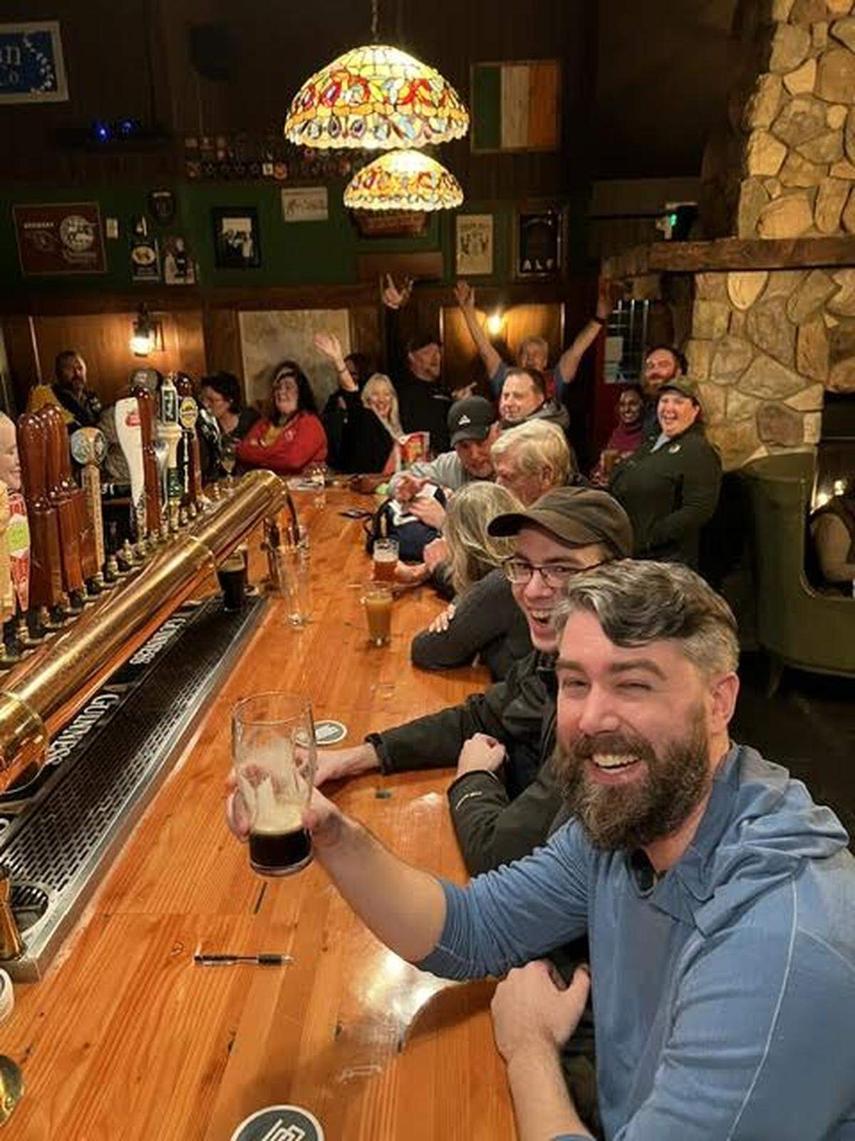 Patrons raise a pint at O’Looney’s Irish Pub in Gig Harbor, Wash.