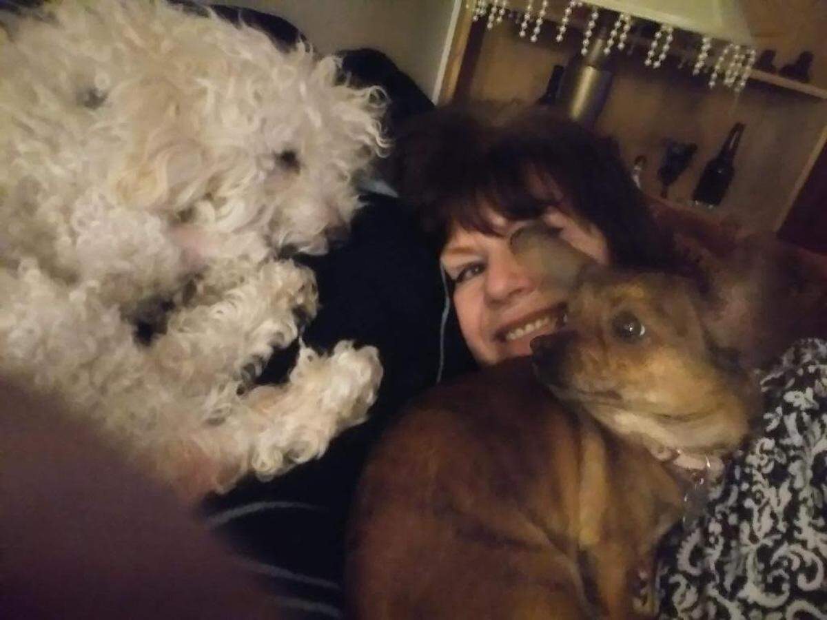 Kim Morgan with her two dogs, Curly and Baggies. Morgan’s subsidized housing is at risk, which she says has caused her stress and exacerbated her medical conditions.