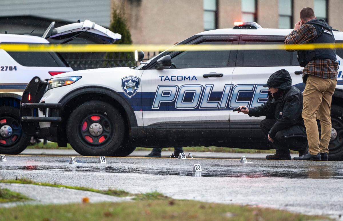 Crime scene technicians and the Pierce County Force Investigation Team investigate the scene where a person was shot and killed early Friday morning by a Tacoma Police Department officer after the person fled from police investigating them in a parked car near Pacific Avenue, and the shooting occurred at McKinley Avenue and East 57th Street in Tacoma, Wash. on Dec. 30, 2022.