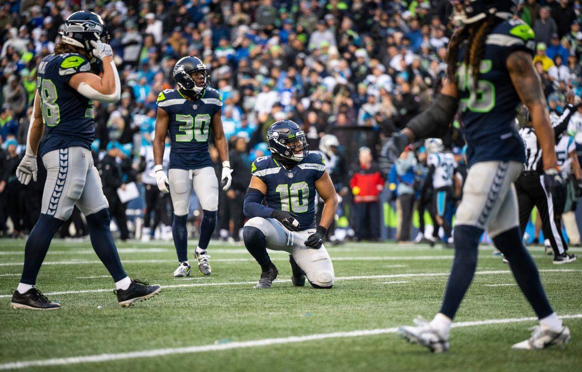 Seattle Seahawks linebacker Uchenna Nwosu (10) kneels after watching the Carolina Panthers score a touchdown in the third quarter of an NFL game at Lumen Field in Seattle Wash., on Dec. 11, 2022. The Seahawks lost to the Panthers 24-30.