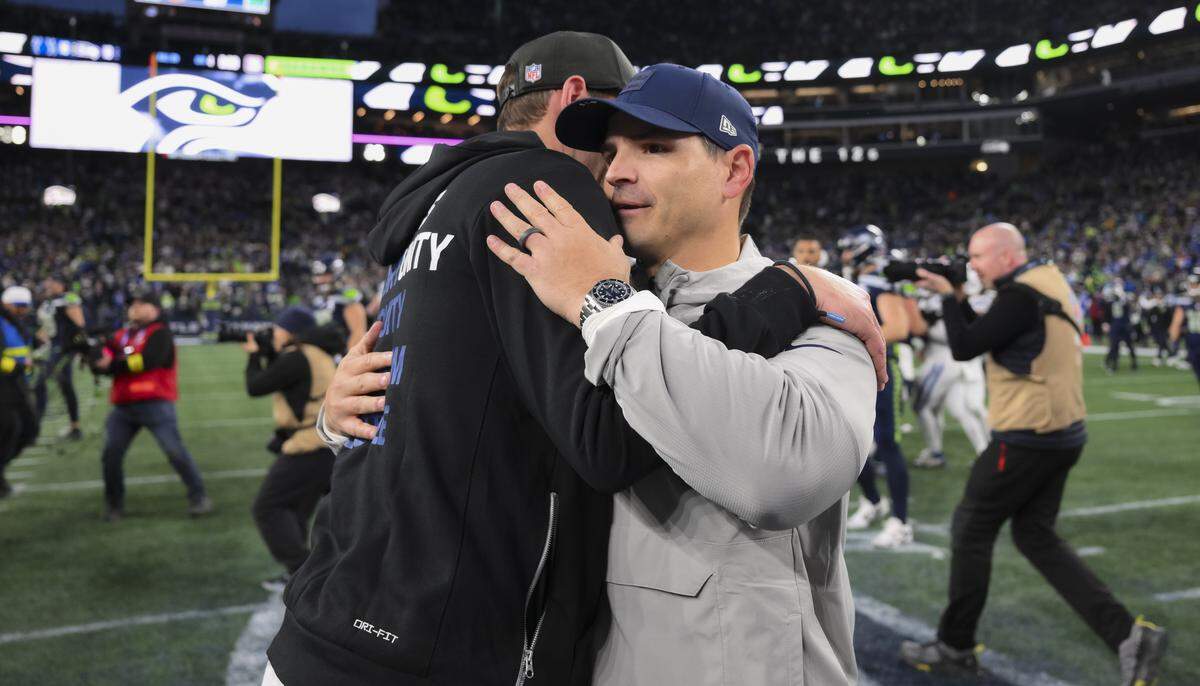 Seattle Seahawks head coach Mike MacDonald and Indianapolis Colts head coach Shane Steichen embrace after the Seattle Seahawks 18-16 victory at Lumen Field, on Sunday, Dec. 14, 2025, in Seattle.