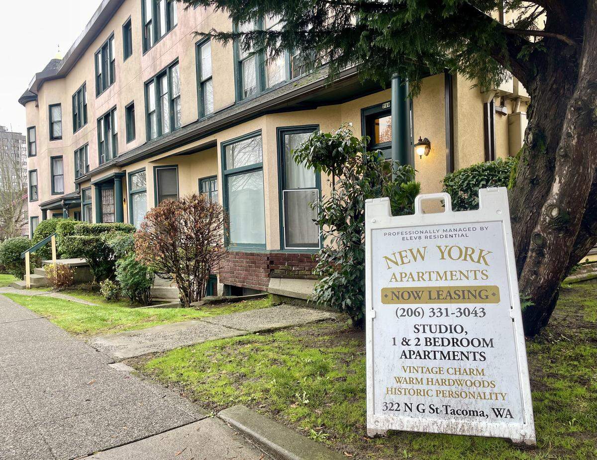 A sign advertises apartments for lease outside of New York Apartments in Tacoma on Dec. 11, 2025.