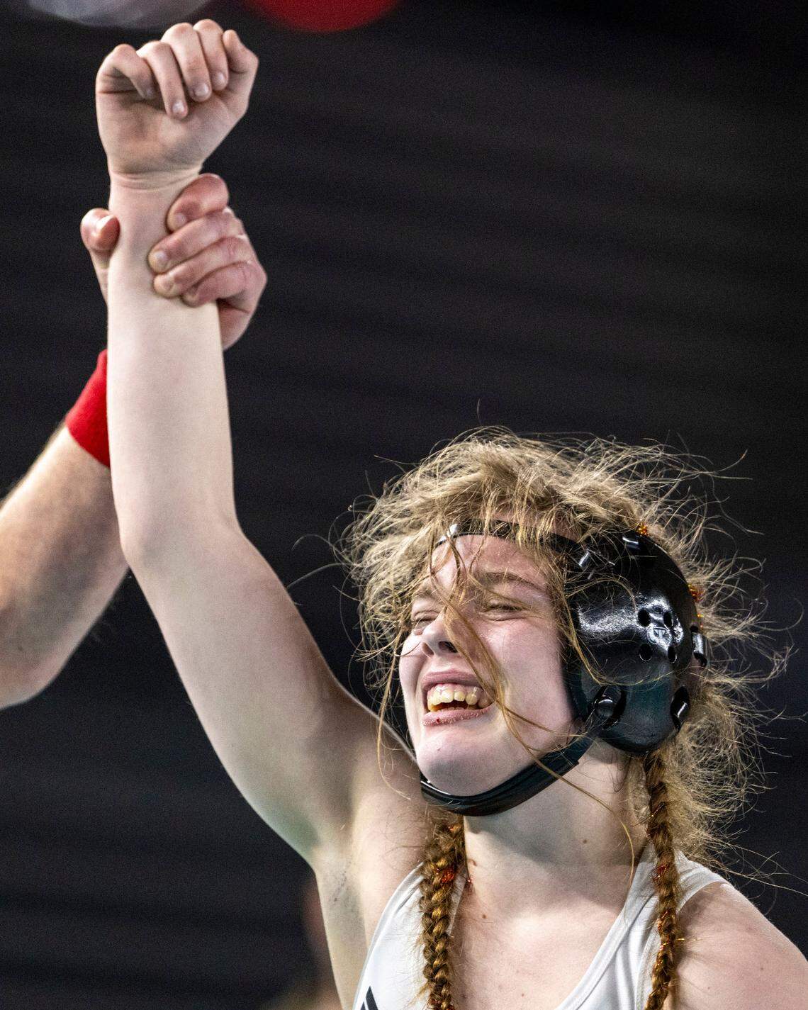 The match referee lifts up the arm of Orting’s Madison Watts after she defeated Aberdeen’s Felicia Bell to win the Class 2A, 125-pound state title on Saturday, Feb. 22, 2025, at Mat Classic XXXVI at the Tacoma Dome in Tacoma, Wash.
