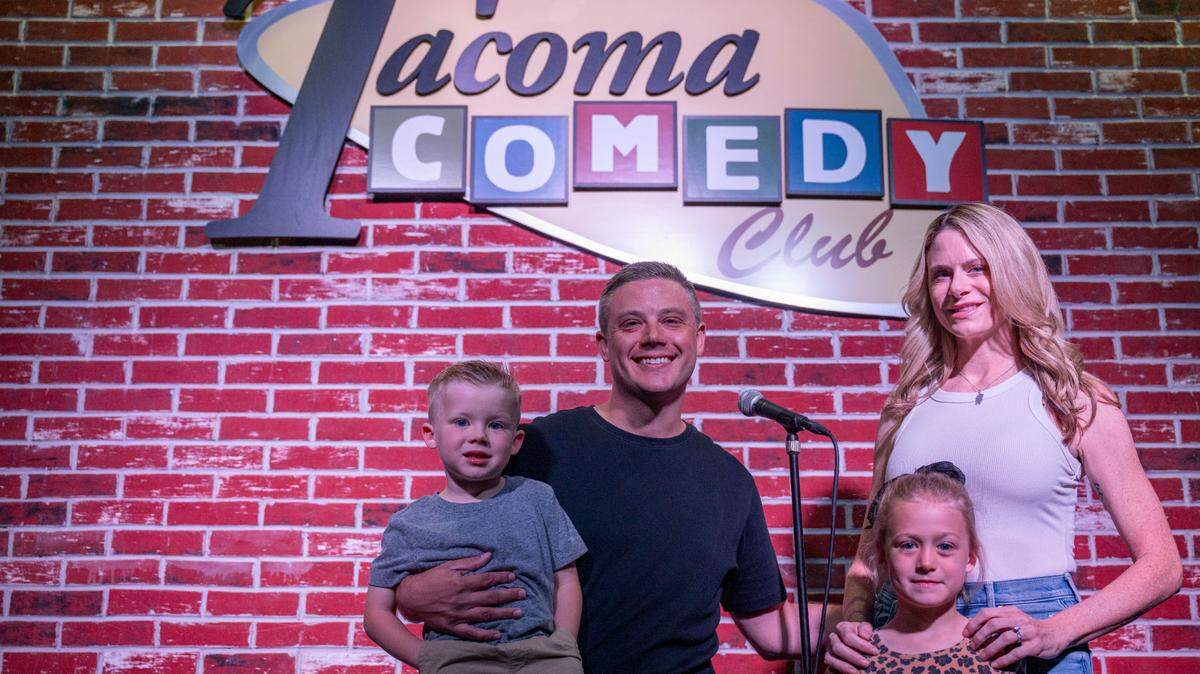 Tacoma Comedy Club owners Adam and Bree Norwest pose for a portrait with their son, Rowen, 4, and daughter, Ava, 6, while on stage at their new club location on 6th Avenue on Monday, July 3, 2023, in Tacoma, Wash.