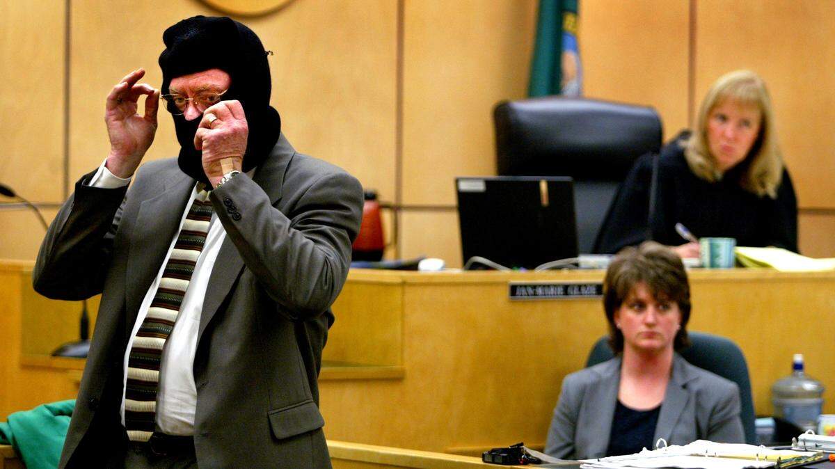 Defense attorney Monte Hester dons a ski mask Oct. 21, 2002, to demonstrate to a jury how an officer wearing such gear in the dark could be mistaken for an intruder. Hester was delivering an opening statement in the third murder trial for Brian Eggleston.