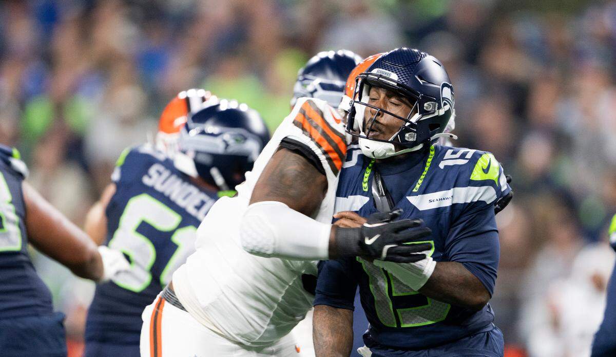 Seattle Seahawks quarterback PJ Walker (15) takes a hit from Cleveland Browns defensive tackle Mike Hall Jr. (51) during the fourth quarter of the preseason game at Lumen Field, on Saturday, Aug. 24, 2024 in Seattle, Wash.