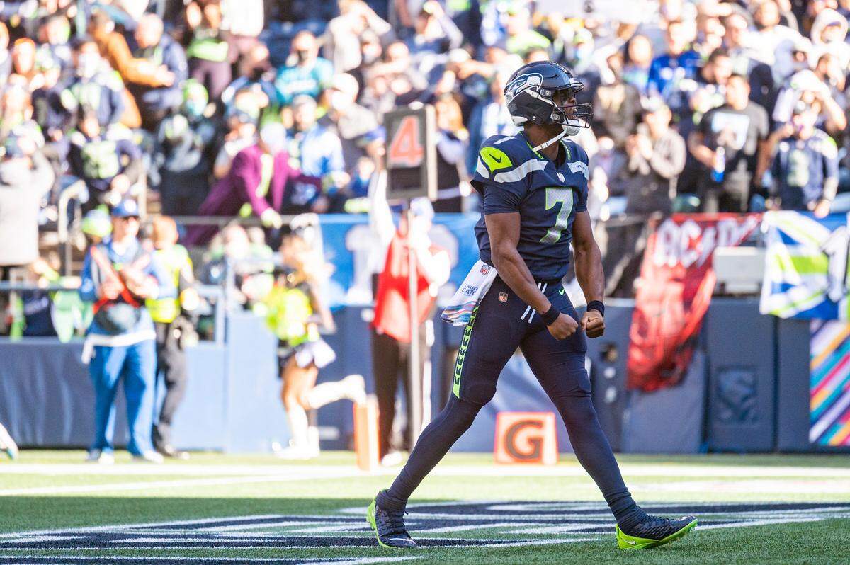 Seattle Seahawks quarterback Geno Smith (7) celebrates after leaping into the endzone for a one-yard rushing touchdown during the first quarter of an NFL game against the Jacksonville Jaguars on Sunday at Lumen Field in Seattle.