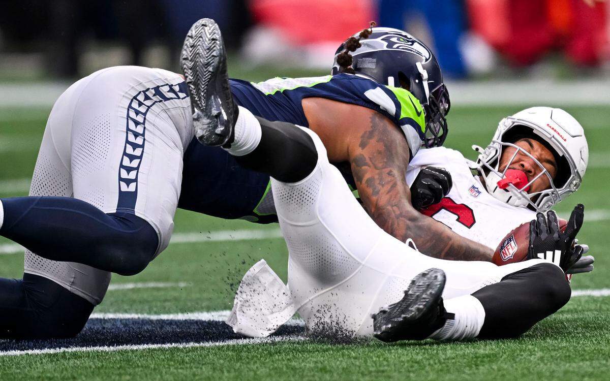 Seattle Seahawks defensive end Leonard Williams (99) slams Arizona Cardinals running back James Conner (6) to the ground during the third quarter of the game at Lumen Field, on Sunday, Nov. 24, 2024, in Seattle, Wash.