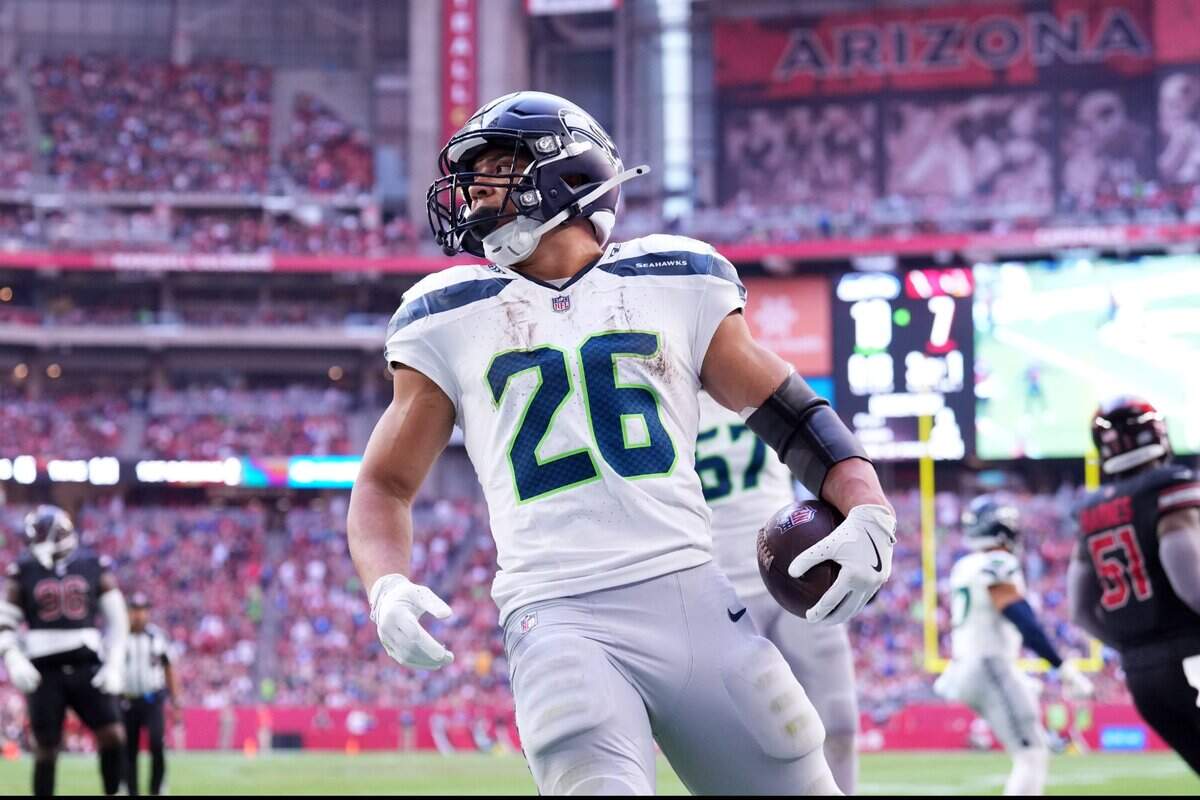 Seattle Seahawks running back Zach Charbonnet (26) runs for a touchdown against the Arizona Cardinals during the first half at State Farm Stadium. Mandatory Credit: Joe Camporeale-Imagn Images