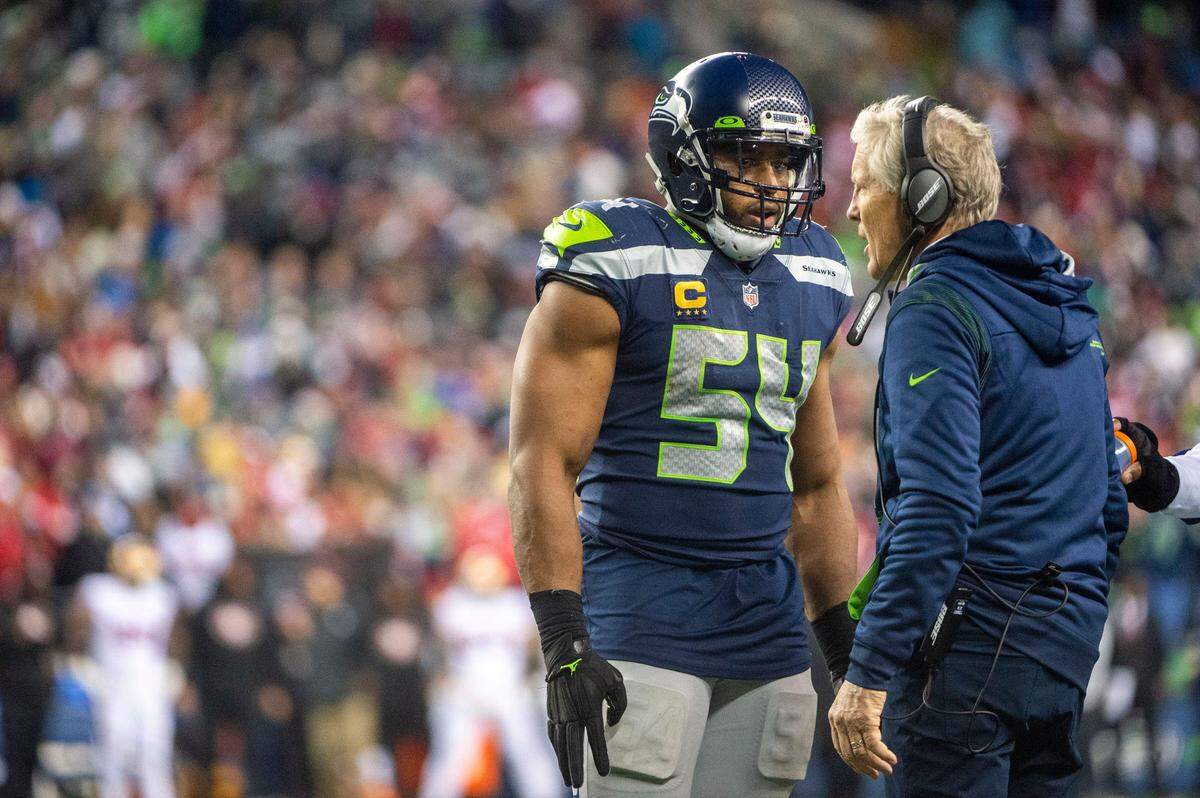 Seattle Seahawks middle linebacker Bobby Wagner (54) talks with head coach Pete Carroll during a timeout just before the San Francisco 49ers fourth-and-goal play during the fourth quarter of an NFL game on Sunday at Lumen Field in Seattle.