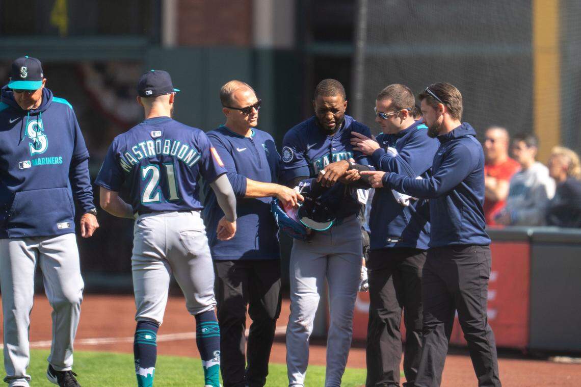 Apr 6, 2025; San Francisco, California, USA; Seattle Mariners right fielder Victor Robles (10) is injured during the play against the San Francisco Giants during the ninth inning attended medical personal at Oracle Park. Mandatory Credit: Neville E. Guard-Imagn Images