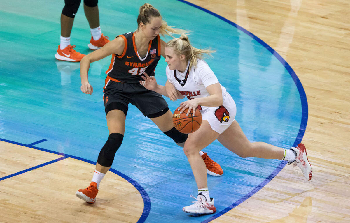 Louisville’s Hailey Van Lith, right, handles the ball as Syracuse’s Digna Strautmane (45) defends during an NCAA college basketball game in the semifinals of Atlantic Coast Conference tournament in Greensboro, N.C., Saturday, March 6, 2021. (AP Photo/Ben McKeown)
