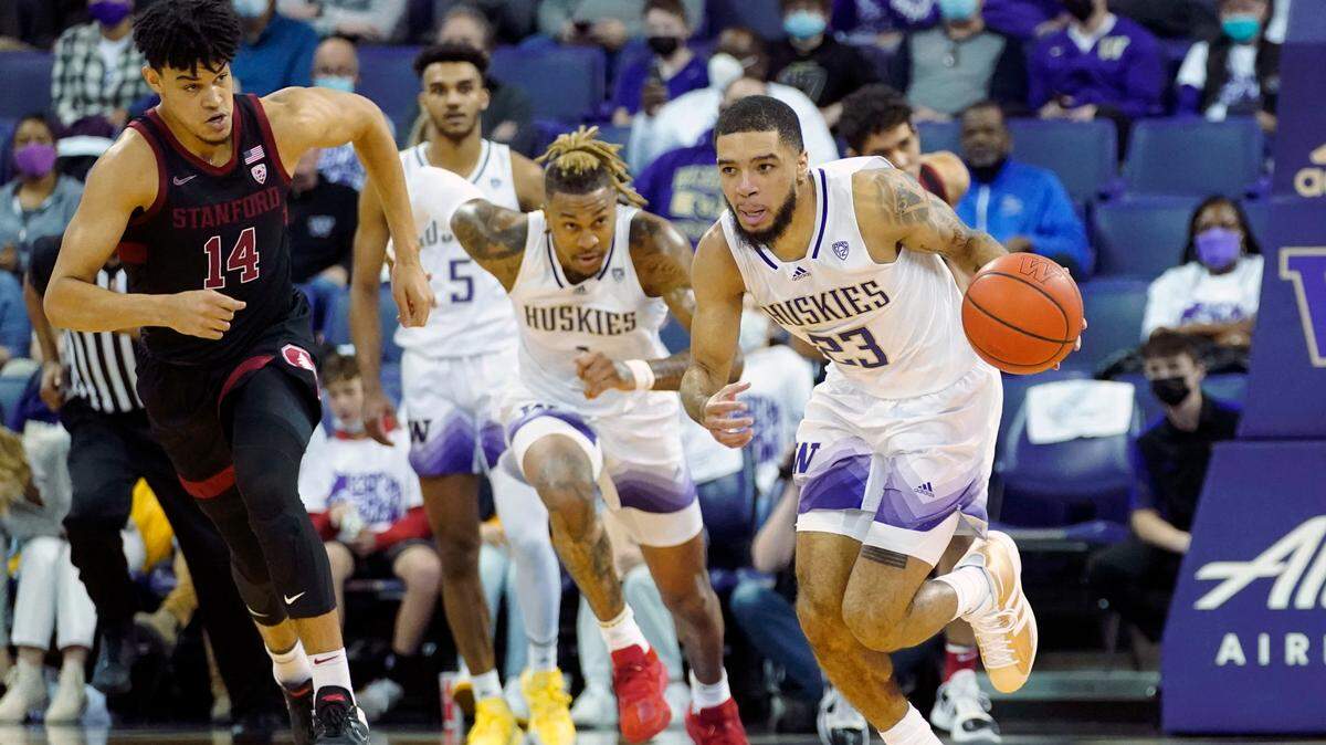Washington guard Terrell Brown Jr. (23) breaks away after a turnover as Stanford forward Spencer Jones (14) looks on during the first half of an NCAA college basketball game, Saturday, Jan. 15, 2022, in Seattle. (AP Photo/Ted S. Warren)