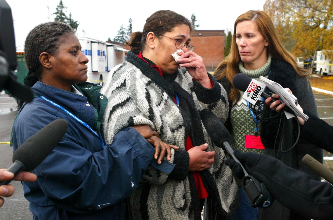Yvette Gervais, center, wipes away tears as she addresses the media regarding her missing 10-year-old daughter Adre'anna Jackson on Dec. 3, 2005. Supporting her are friends Francis Clark, left, and Cynthia Maguire, right.