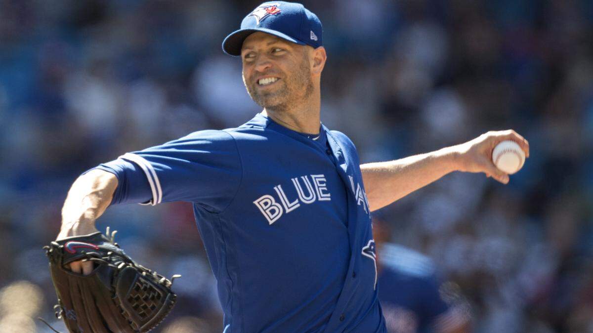 Toronto Blue Jays starting pitcher J.A. Happ works against New York Yankees in the first inning of a baseball game in Toronto on Saturday, July 7, 2018. (Fred Thornhill/The Canadian Press via AP)
