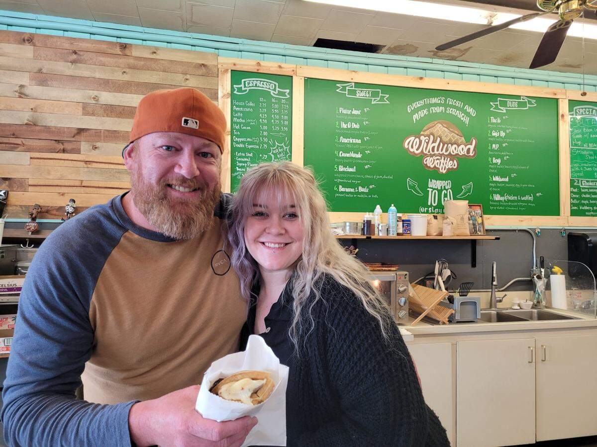Harry Smith (left) moved his business, Wildwood Waffles, from California to Gig Harbor. He opened a stand at Finholm’s Market Jan. 1, 2024. Employees, including Hailey Smith (right), made the move with him.