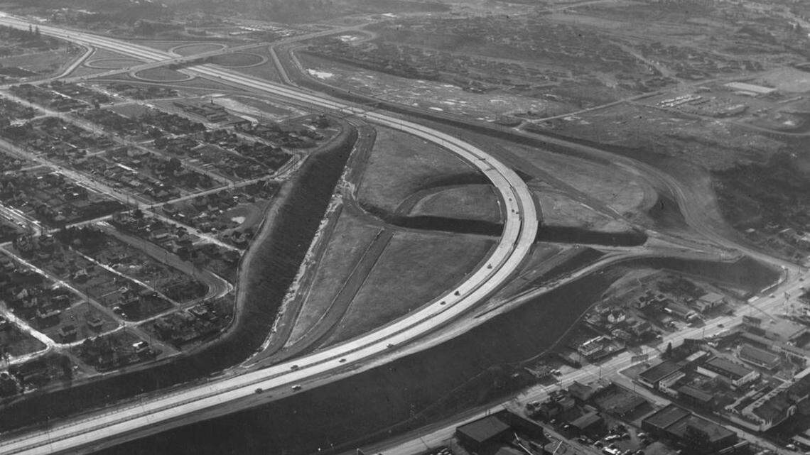 This aerial view of Tacoma, taken from 1,200 feet, shows I-5 and the 38th Street cloverleaf as they appeared in January 1961. The simple curve of the highway had not yet been complicated by the addition of the Highway 16 interchange. The houses to the left are surrounded on the north and west by I-5 and on the south by 38th Street. The buildings at the bottom, right are on South Tacoma Way.