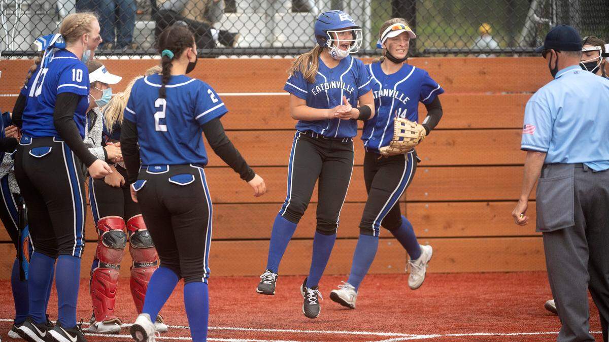 Eatonville’s Kyleigh Backlund (center) and Hailey Rath (14) celebrate with their Cruiser teammates on Haley Smith’s home run during Thursday evening’s 2A SPSL district championship fastpitch game against Franklin Pierce at Foss High School in Tacoma, Washington, on Thursday, May 6, 2021.