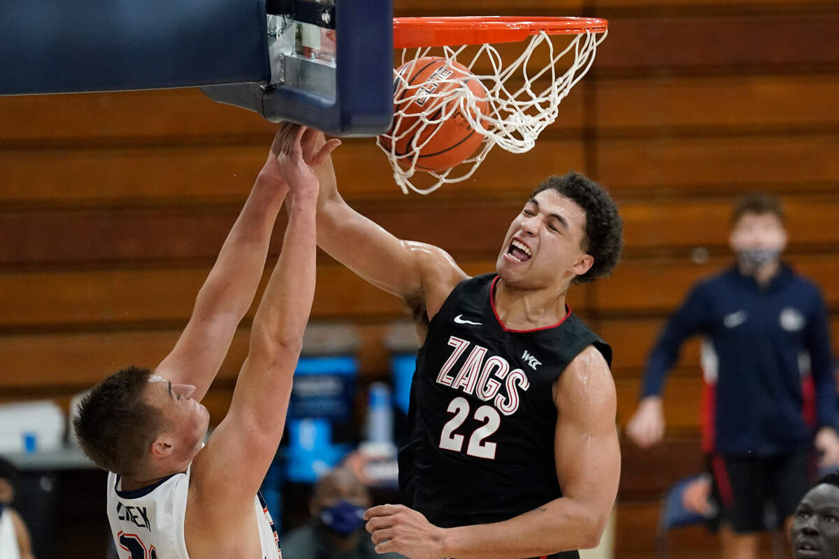 Gonzaga forward Anton Watson (22) dunks against Pepperdine forward Jan Zidek, left, during the second half of an NCAA college basketball game Saturday, Jan 30, 2021, in Malibu, Calif. (AP Photo/Ashley Landis)