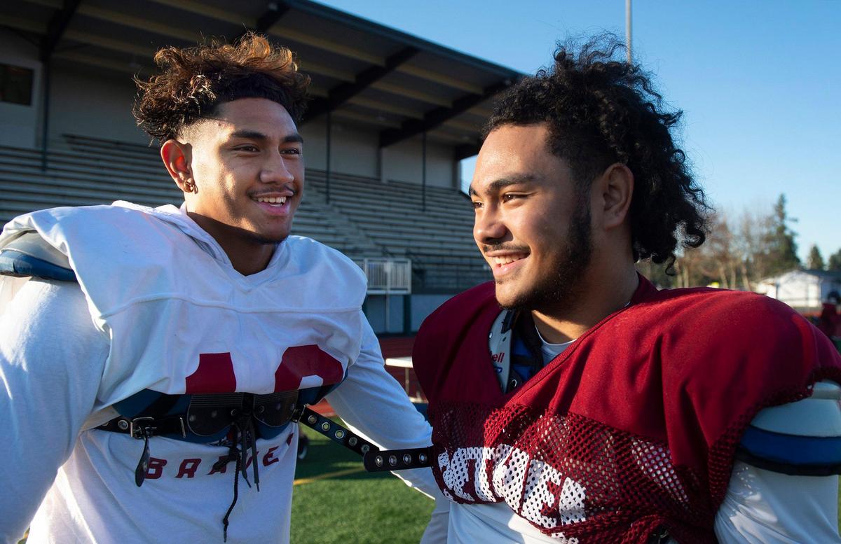 Bethel junior running back Will Latu (right) with his big brother, senior receiver Peter Latu, during football practice at Art Crate Field in Spanaway on Wednesday, Nov. 20, 2019.