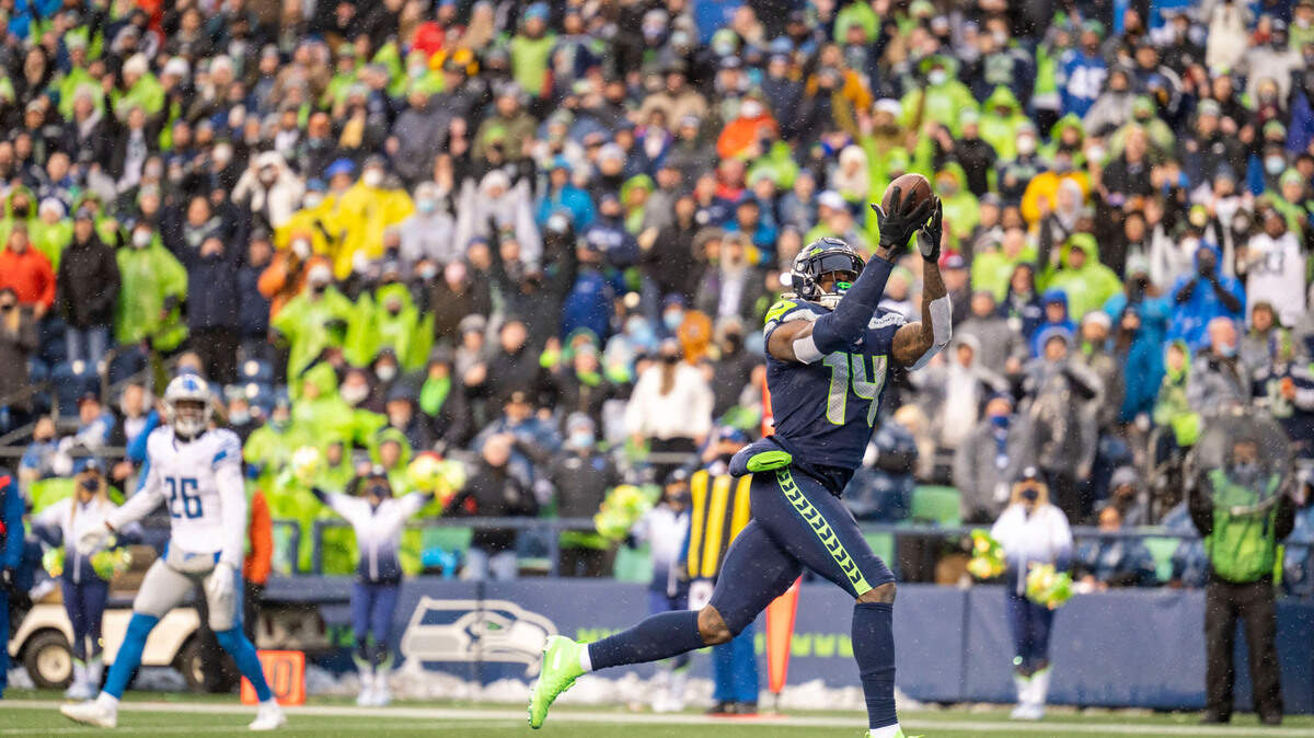 Seattle Seahawks wide receiver DK Metcalf (14) catches a touchdown pass from quarterback Russell Wilson (3) during the second quarter of an NFL game on Sunday, Jan. 2, 2022, at Lumen Field in Seattle.