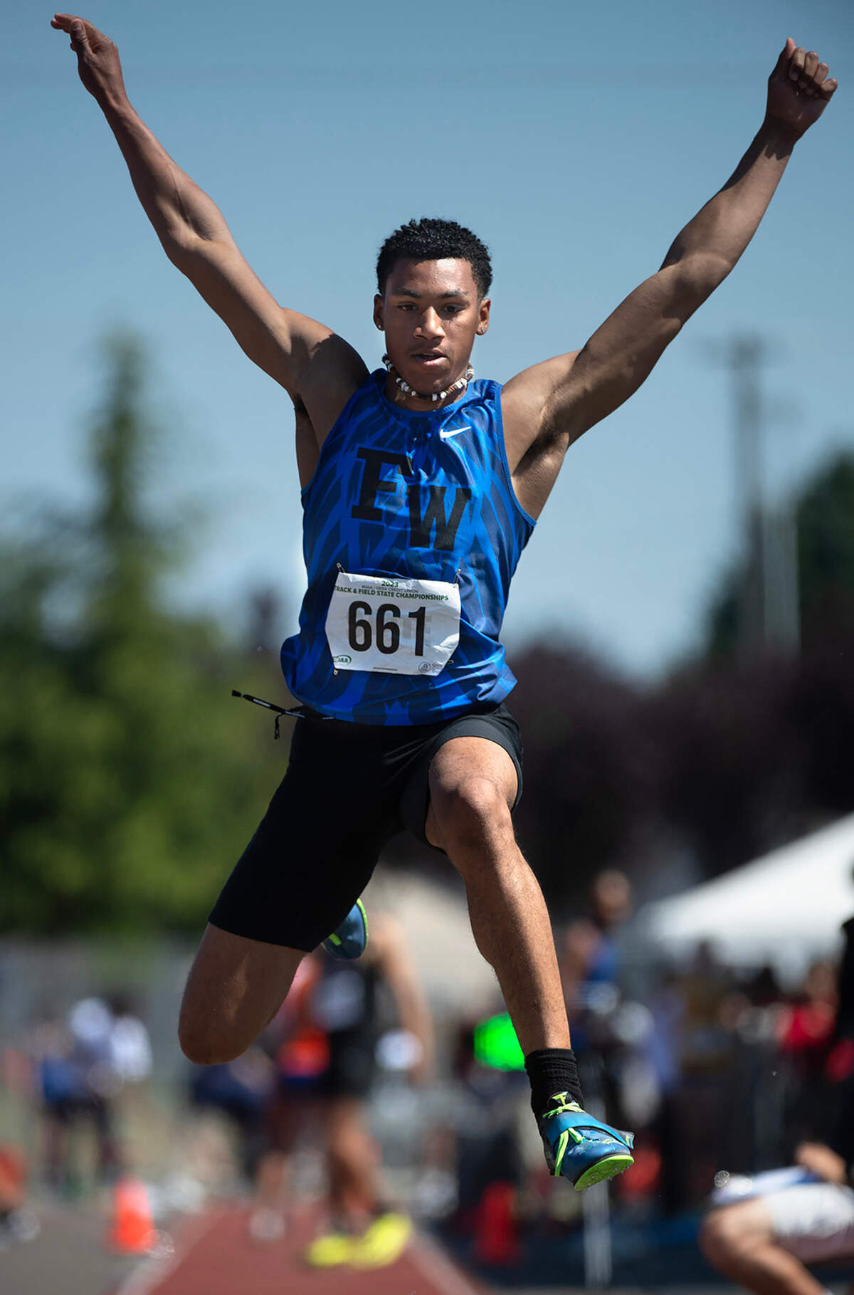Federal Way’s Jaylon Jenkins jumps to a second place finish in the 4A boys triple jump competition during the second day of the WIAA state track and field championships at Mount Tahoma High School in Tacoma, Washington, on Friday, May 26, 2023.