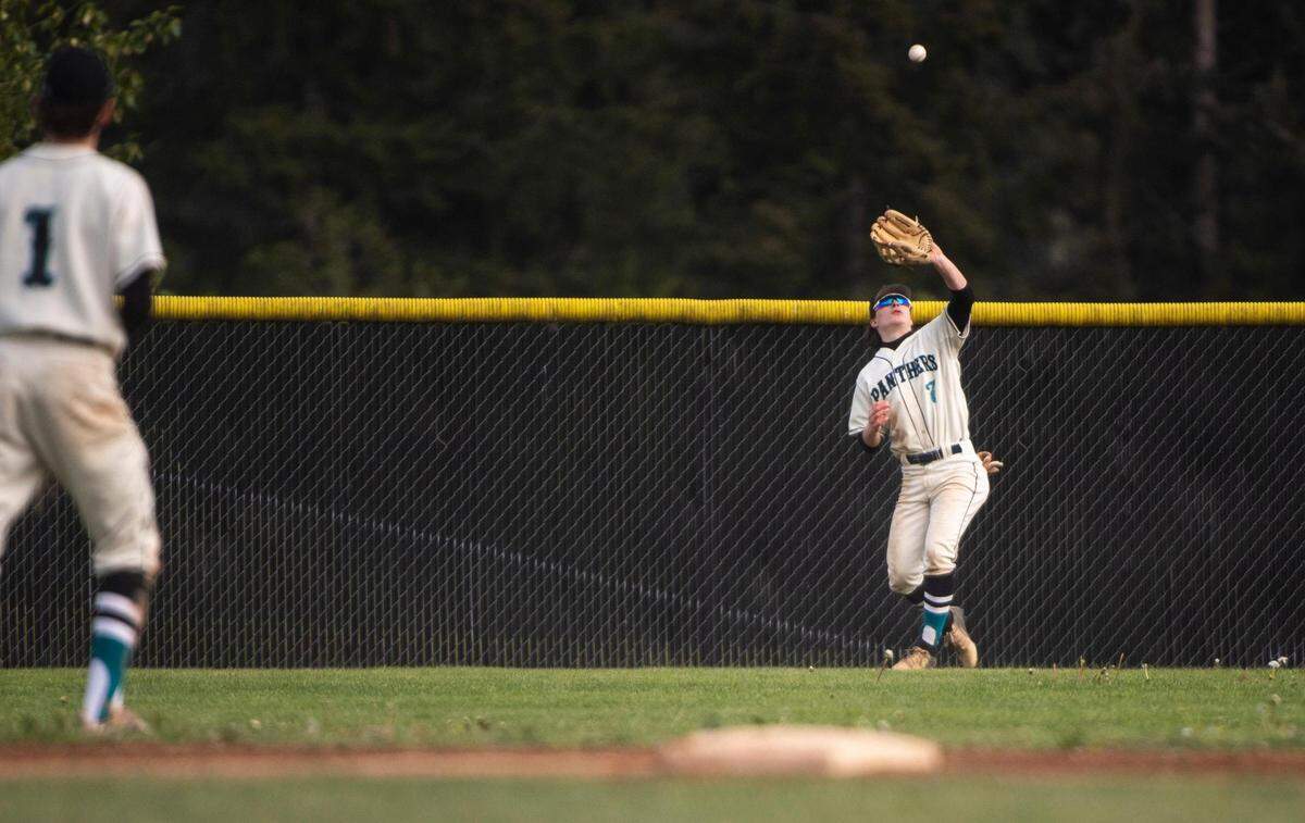 Bonney Lake High School varsity baseball center fielder Brennan Carbonell (7) reaches his glove up to catch the ball during the district tournament game against Bainbridge at Bonney Lake High School in Bonney Lake, Wash. on Saturday, May 7, 2022.