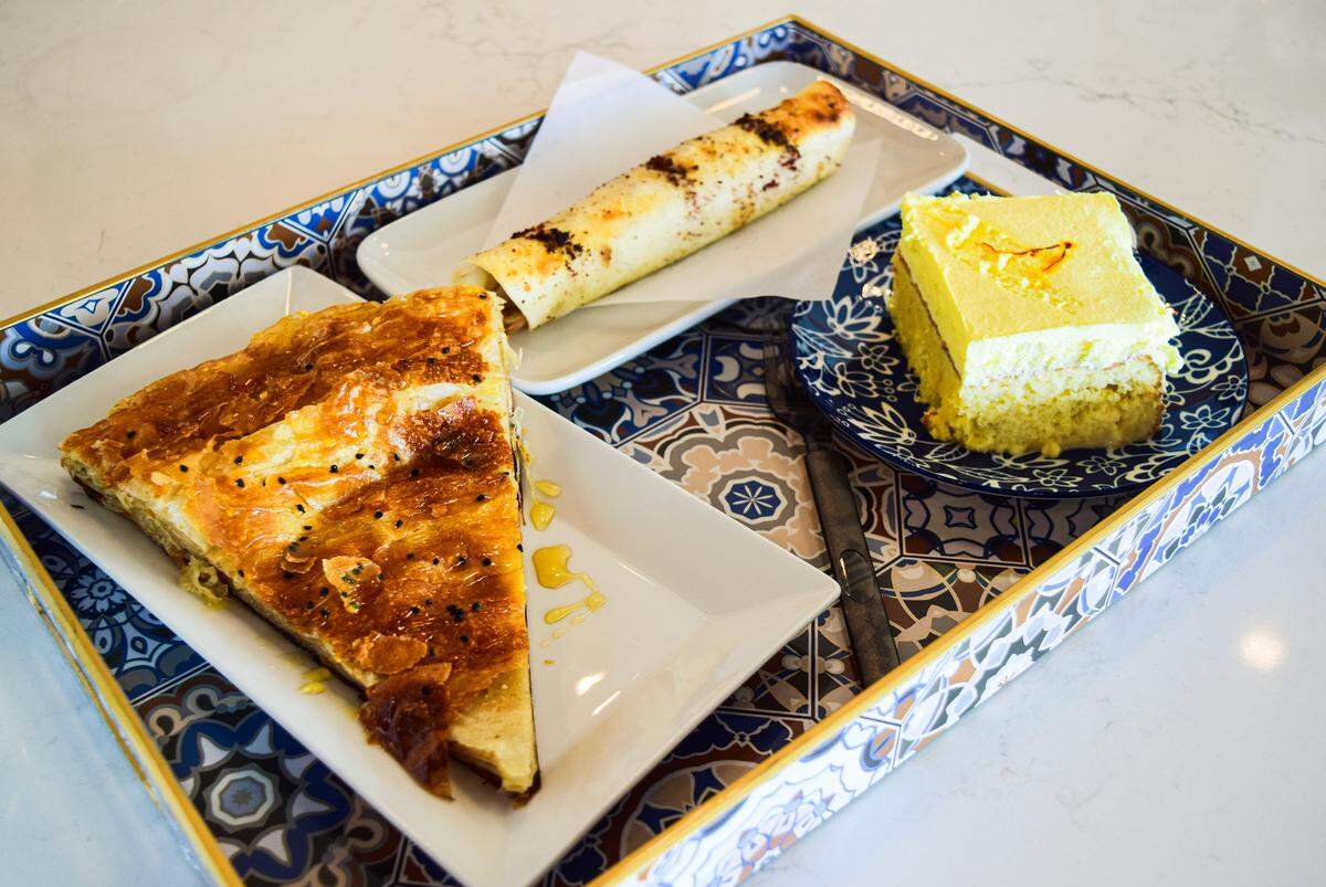Saleh said finding a local bakery to produce the Yemeni pastries was the most challenging part of opening the cafe. Specialties include (clockwise from top) chicken fatayer, saffron tres leches and sabayah.
