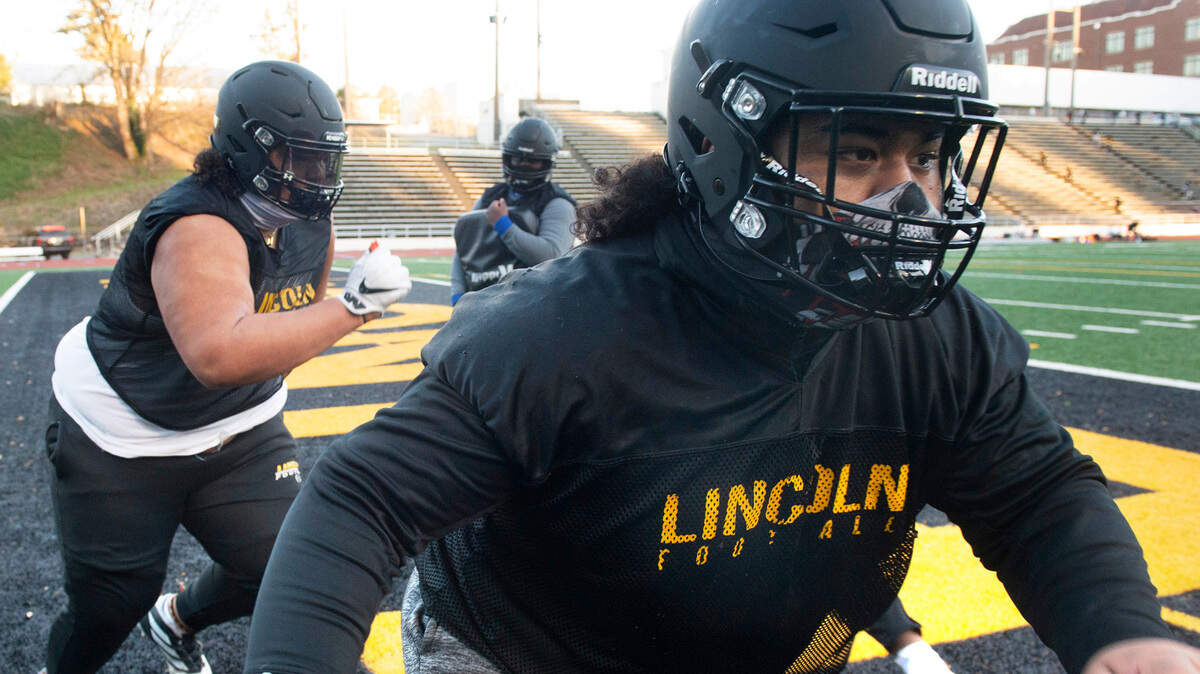 Lincoln guard Trey Meredith (right) and tackle Tapuloa Tusi will help anchor the Abes offensive and defensive lines in 2021. They are shown during football practice at Lincoln High School in Tacoma, Washington on Wednesday, Feb. 10, 2021.