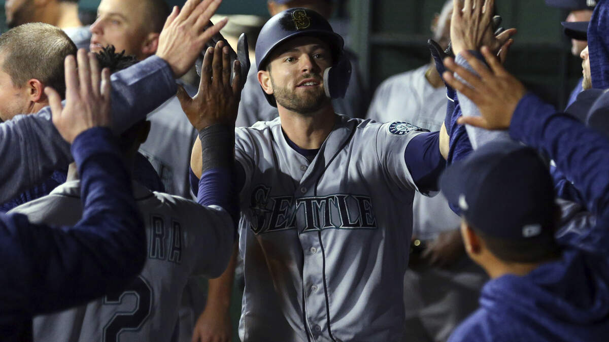 Seattle Mariners Mitch Haniger (17) is greeted in the dugout after hitting a game-tying home run against the Texas Rangers in the eighth inning of a baseball game Friday, April 20, 2018, in Arlington, Texas. (AP Photo/Richard W. Rodriguez)