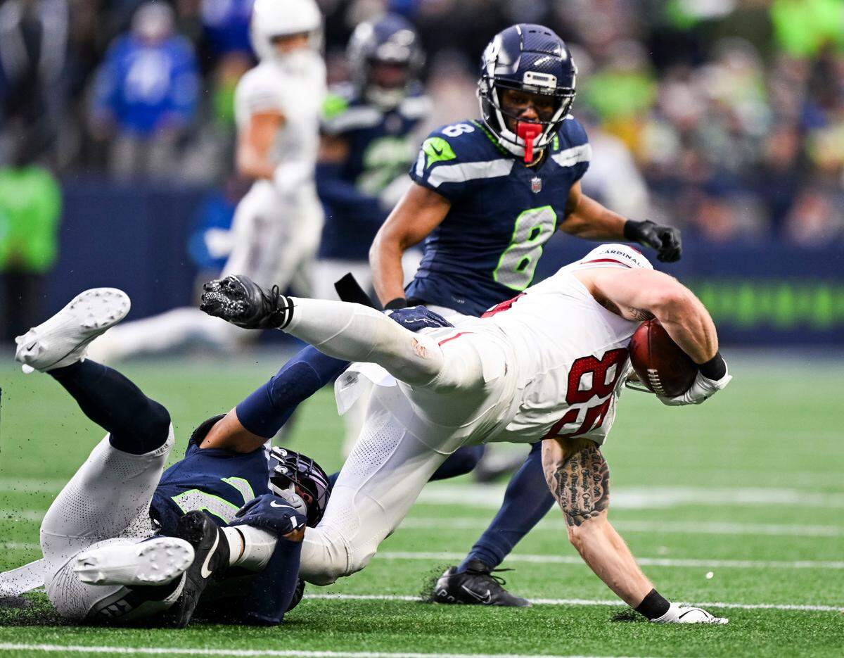 Arizona Cardinals tight end Trey McBride (85) is tackled by Seattle Seahawks safety Julian Love (20 ) during the fourth quarter of the game at Lumen Field, on Sunday, Nov. 24, 2024, in Seattle, Wash.