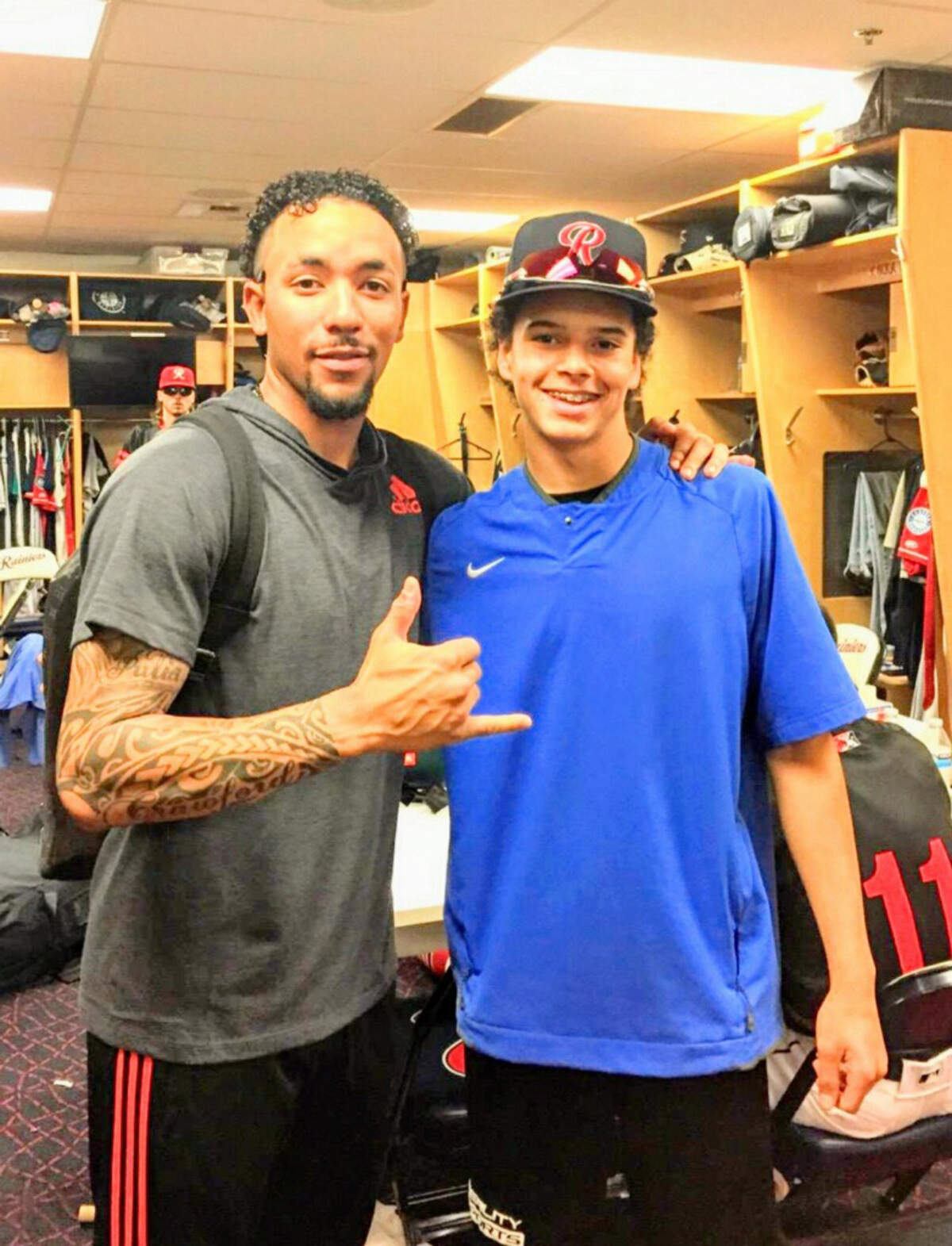 Mariners shortstop J.P. Crawford, then with the Rainiers, and Curtis High School’s Josiah O’Bannon, who was a bat boy for Tacoma, are shown in the Rainiers clubhouse at Cheney Stadium in 2019.