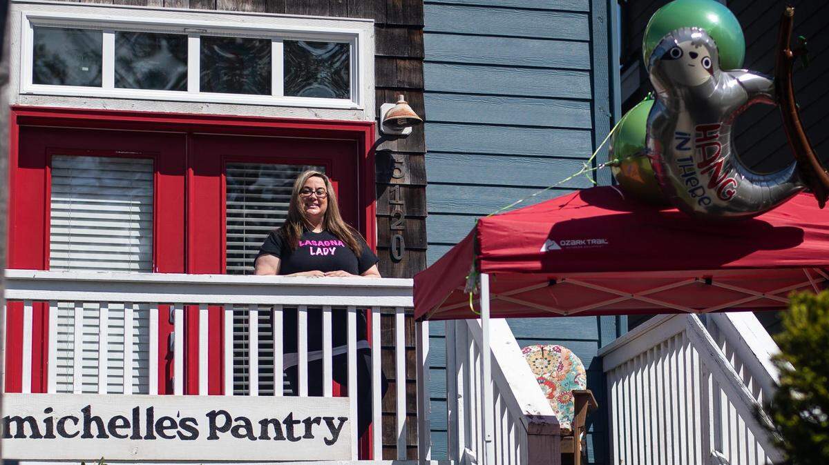 Michelle Brenner, shown on her porch last week, will have to stop giving away lasagna made in her home kitchen, the health department says.