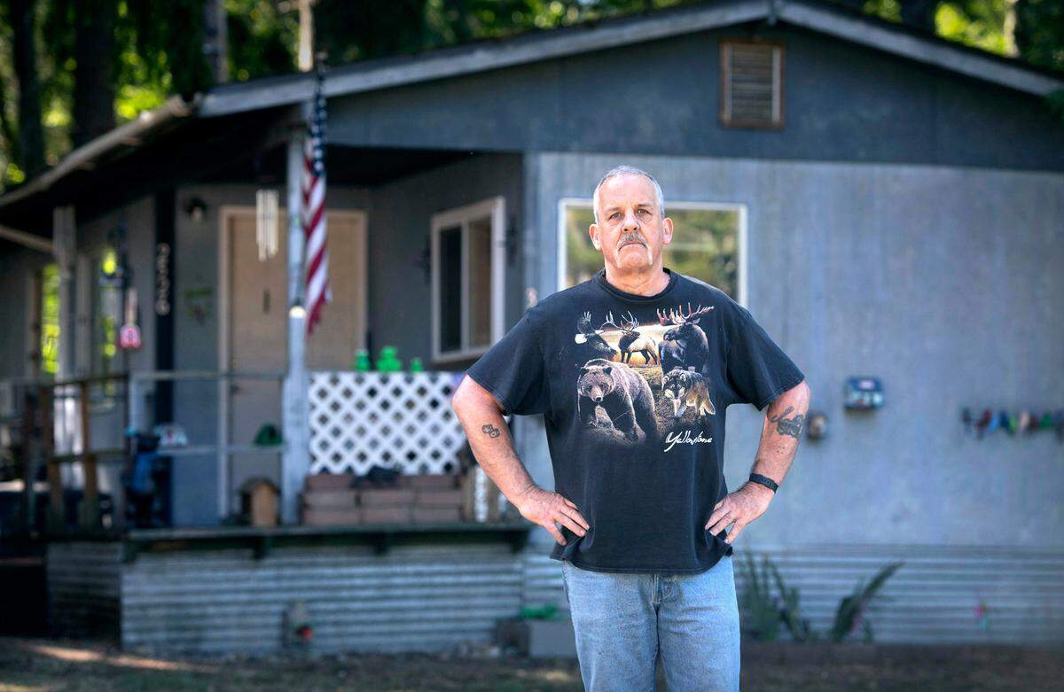 Patrick Froslie stood up to his new property owner who insisted Froslie pay rent for his mobile home and tried to sell the home and have Froslie and his wife evicted. Froslie received a temporary protection order for his wife against the property owner, but “I think he still thinks he owns it,” he said. Froslie is shown outside his home at the Little Lake Mobile Home Park in Roy, Washington on Thursday, Sept. 8, 2022.