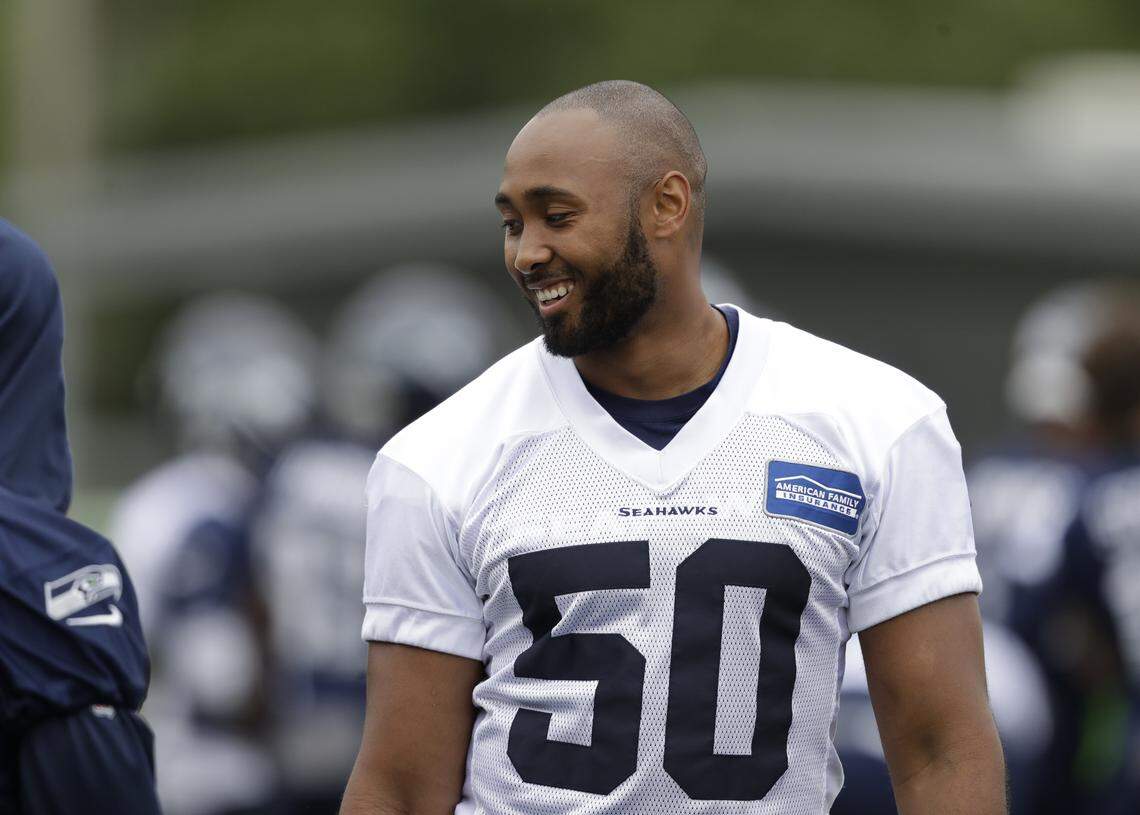 Seattle Seahawks' K.J. Wright stands on the field during an NFL football practice Tuesday, June 12, 2018, in Renton, Wash. (AP Photo/Elaine Thompson)