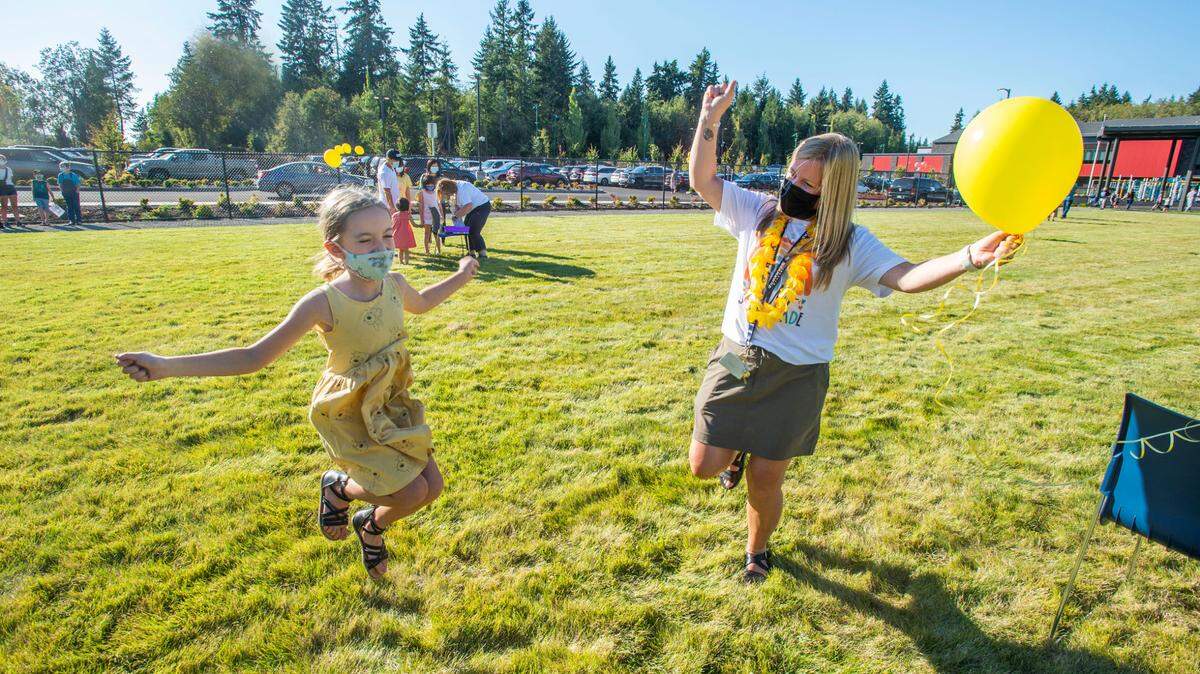 Presley Hazen, 7, literally jumps for joy when her second grade teacher, Missy DeWalt, asked how excited she was to go back to school at an open house Thursday, Sept. 2, 2021. She’ll be attending Swift Water Elementary in Gig Harbor, a brand new school in the Peninsula School District.