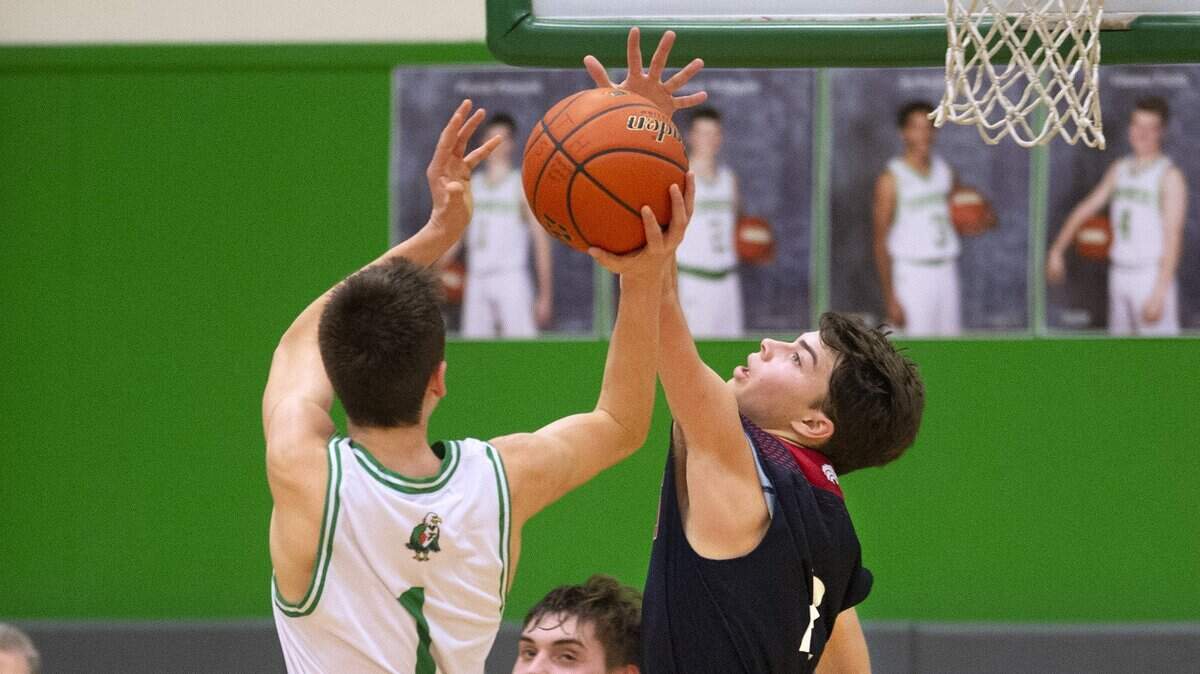Tumwater’s Peyton Peterson flies down the lane against Black Hills defender Avery Armin during Friday night’s boys basketball game at Tumwater High School Jan. 18, 2019.