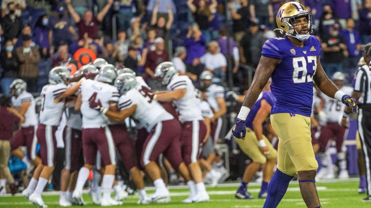UW tight end Devin Culp walks off the field as Montana celebrates their upset 13-7 win. The Washington Huskies played the Montana Grizzlies at Husky Stadium in Seattle, Wash., on Saturday, Sept. 4, 2021.