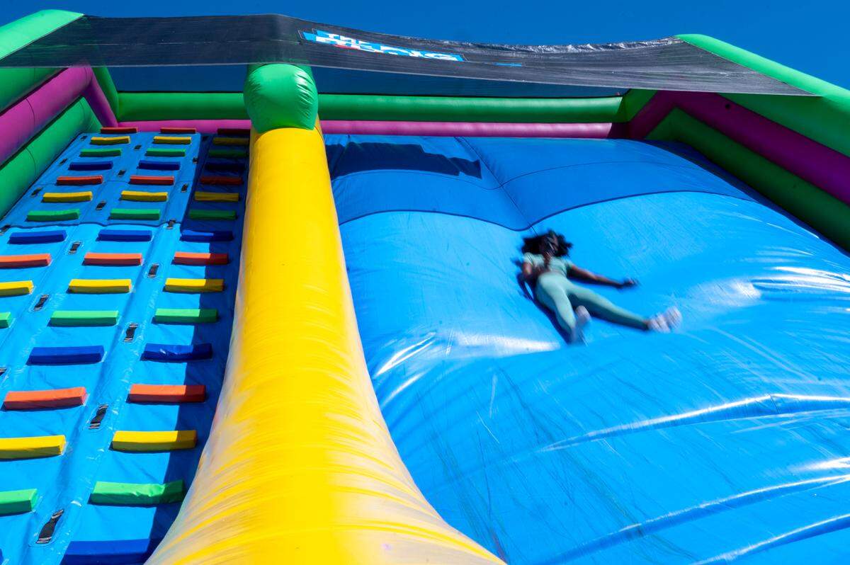 News Tribune reporter Sephora Charles slides down the tallest slide in The World’s Biggest Bounce House, the main attraction of The Big Bounce America tour, on Friday, July 11, 2025, at the Puyallup fairgrounds in Puyallup, Wash.