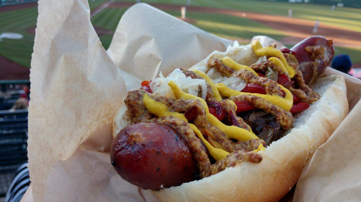 Find this bratwurst at the R Haus Brat stand in a new location at Cheney Stadium for the 2019 Rainiers season. It will be right next door to the Fowl Territory stand along the third base side of Cheney.