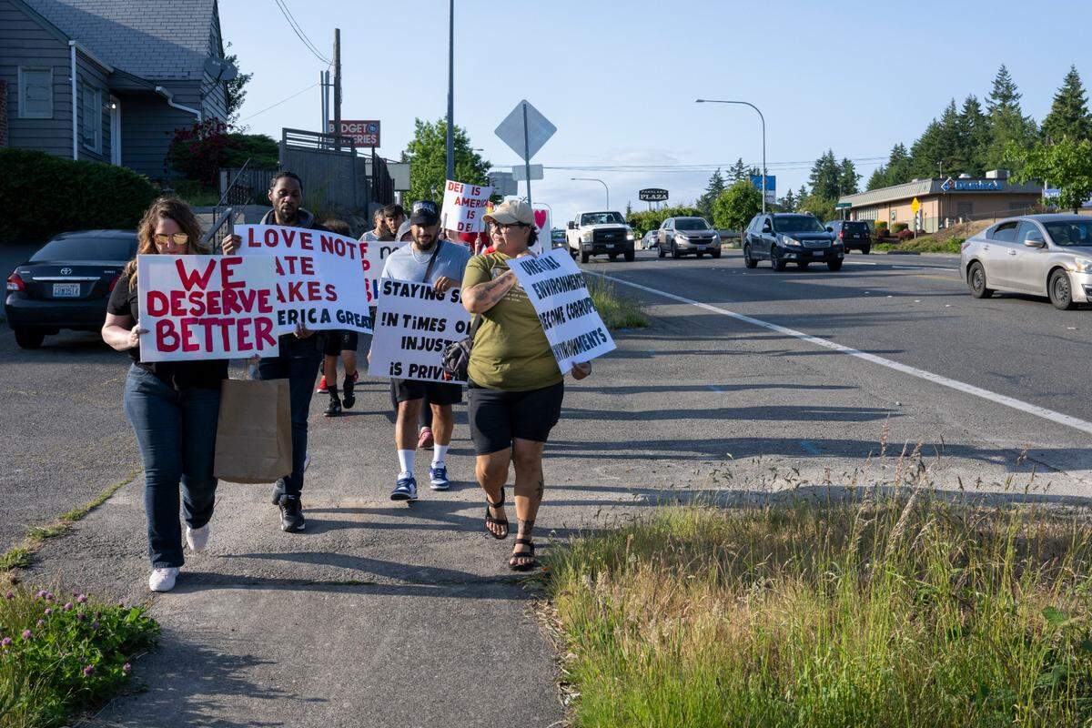A group of roughly 15 parents, staff and students marches to the Franklin Pierce School District administrative center to call attention to issues like discrimination and budgetary cuts at a school board meeting on Tuesday, June 3, 2025, in Tacoma, Wash.
