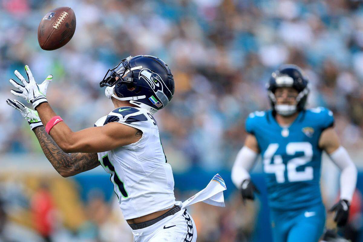 JACKSONVILLE, FLORIDA - OCTOBER 12: Jaxon Smith-Njigba #11 of the Seattle Seahawks catches a touchdown pass during the second quarter against the Jacksonville Jaguars in the game at EverBank Stadium on October 12, 2025 in Jacksonville, Florida. (Photo by Mike Carlson/Getty Images)