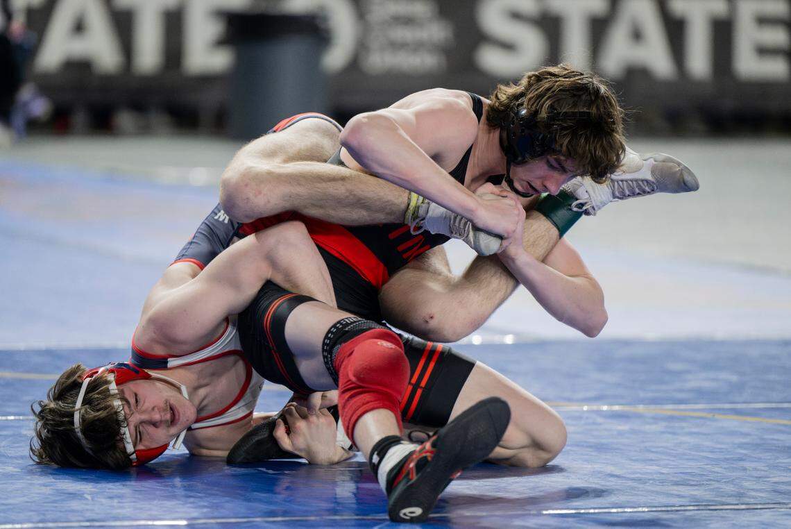 Orting’s Quentin Harding attempts to shirk Black Hills’ Khristian Brant off his back in their 138-pound 2A semifinal match during day two of the Mat Classic XXXV at the Tacoma Dome on Saturday, Feb. 17, 2024, in Tacoma, Washington.