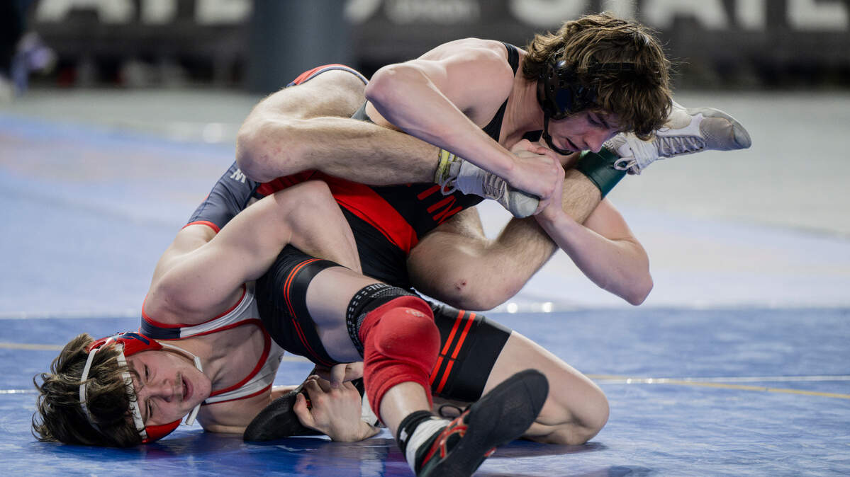 Orting’s Quentin Harding attempts to shirk Black Hills’ Khristian Brant off his back in their 138-pound 2A semifinal match during day two of the Mat Classic XXXV at the Tacoma Dome on Saturday, Feb. 17, 2024, in Tacoma, Washington.