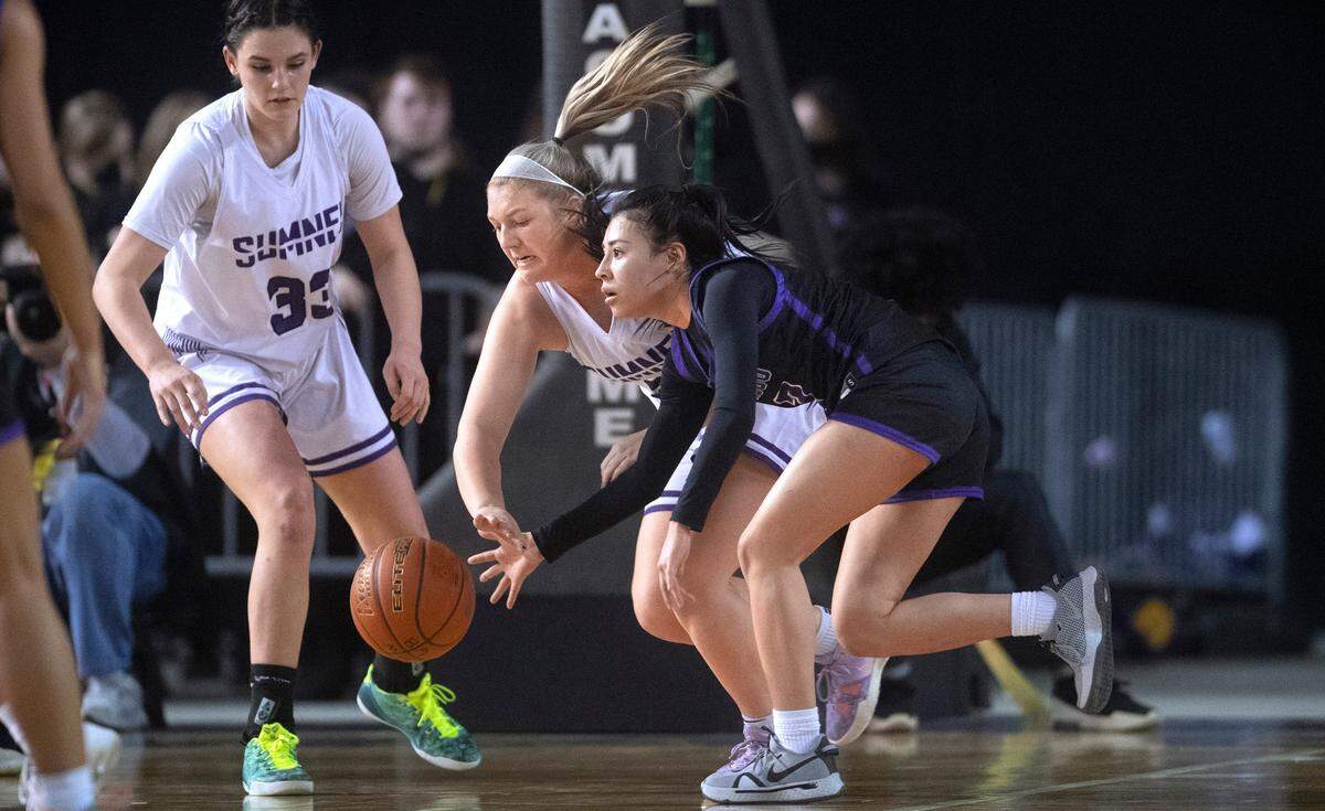 Sumner defender Payton Marinson (center) steals the ball from Pasco’s Leanna Lepe during Friday evening’s semifinal game of the WIAA 4A Girls Basketball State Championships tournament in the Tacoma Dome in Tacoma, Washington, on Friday, March 4, 2022.