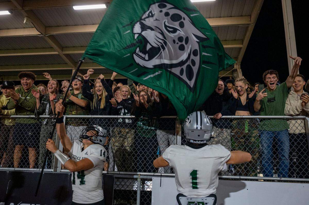 Emerald Ridge quarterback Jake Schakel waves the school’s flag in front of the student section after leading his team to a 28-18 win over Sumner in a 4A SPSL game on Friday, Sept. 16, 2022, at Sunset Chev Stadium in Sumner, Wash.
