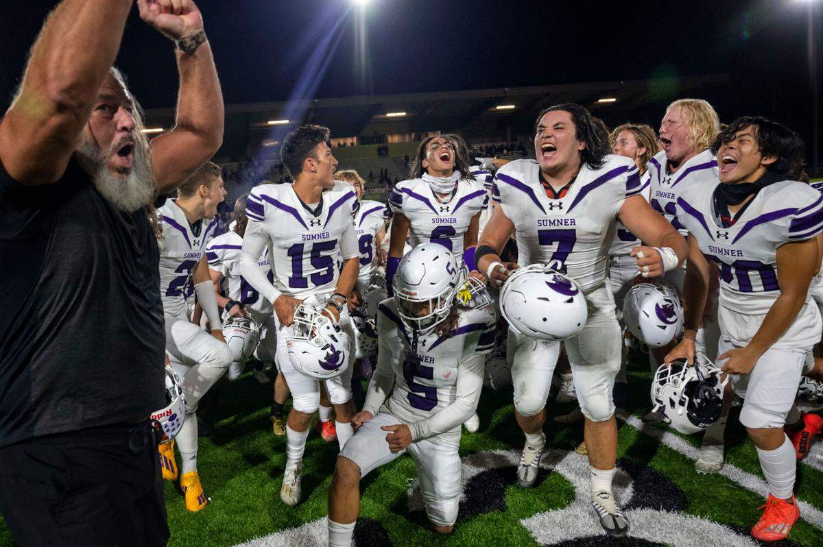 Sumner head coach Keith Ross leads the celebration after the Spartans beat Puyallup, 40-10 in a 4A SPSL game on Friday, Sept. 23, 2022, at Sparks Stadium in Puyallup, Wash.